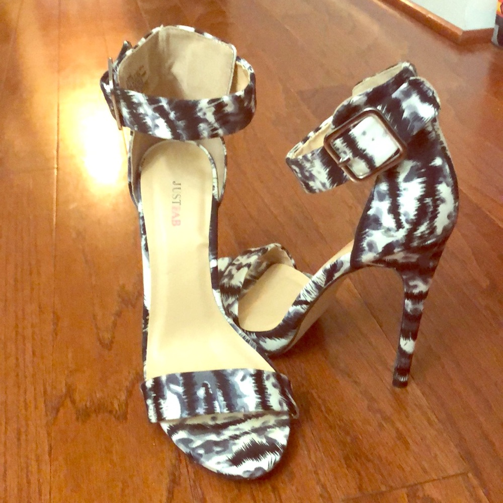 White & black open toe sandals with a heel